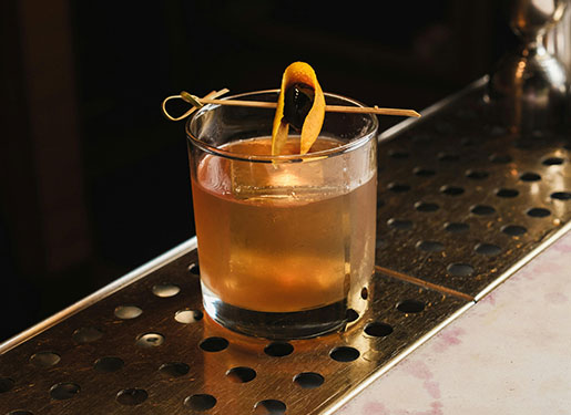 whiskey cocktail with oragne peel