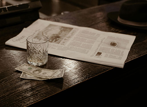 magazine and empty glass at bar